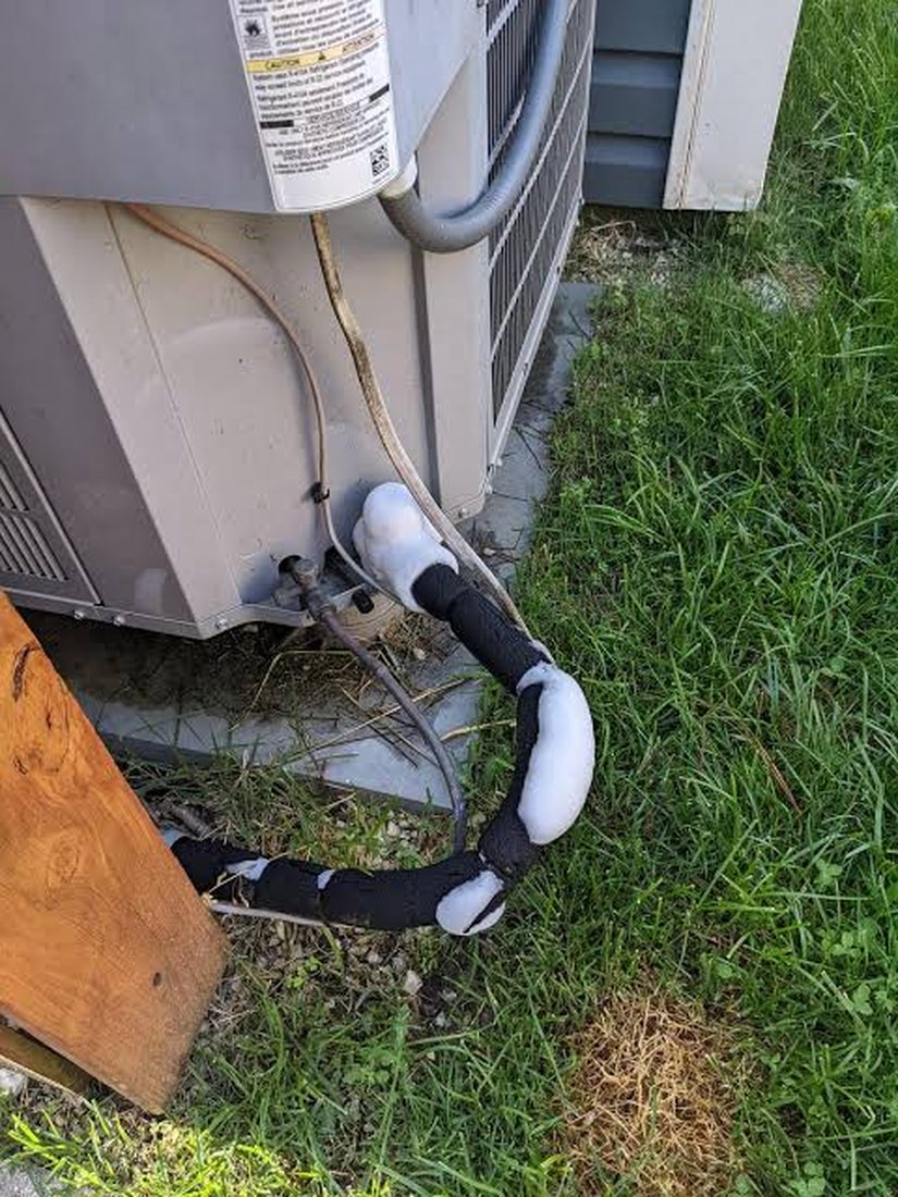 Outdoor AC unit with frozen pipe needing refrigerant service and diagnosis
