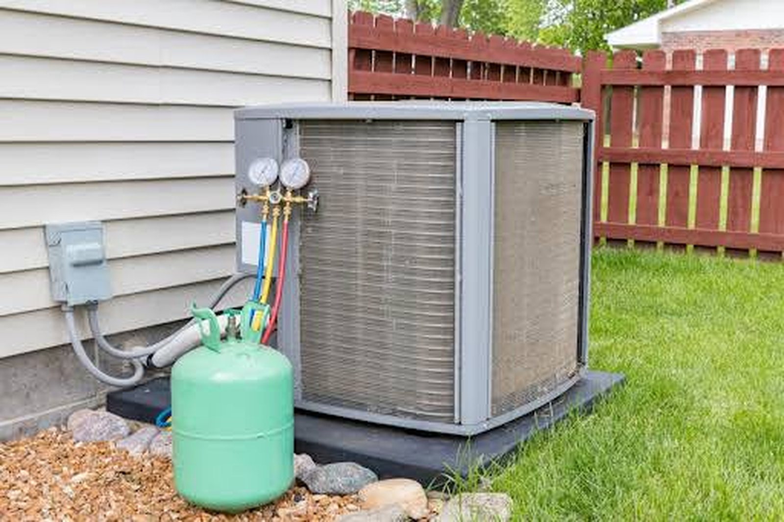 Residential outdoor air conditioner connected to a refrigerant cylinder for AC recharge
